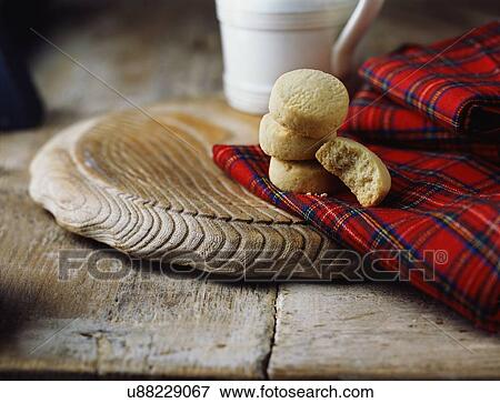 Stock Photo - Luxury Scottish all butter shortbread rounds on tartan tea towel. Fotosearch
