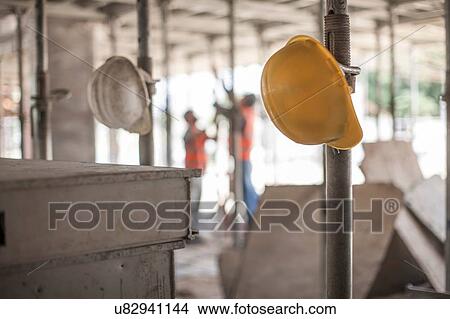 Male builders working on scaffolding on construction site View Large Photo Image Picture - Male builders working on scaffolding on construction site. Fotosearch