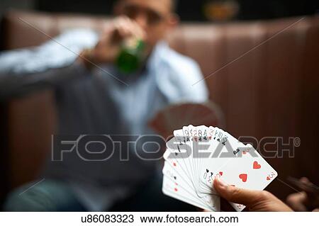 Male hand playing cards in traditional UK pub View Large Photo Image Stock Image - Male hand playing cards in traditional UK pub. Fotosearch