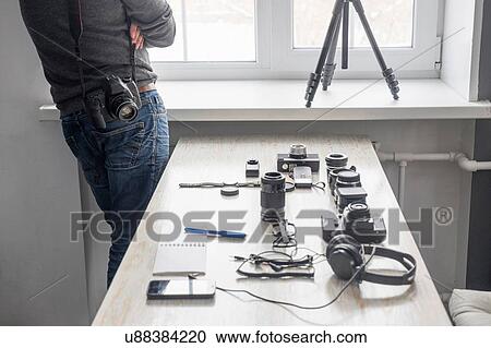 Male photographer next to photography equipment on studio desk View Large Photo Image Stock Image - Male photographer next to photography equipment on studio desk. Fotosearch