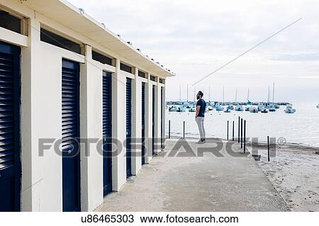 Male tourist next to changing block by the sea, Tuscany, Italy View Large Photo Image Stock Image - Male tourist next to changing block by the sea, Tuscany, Italy. Fotosearch