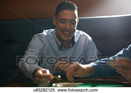 Man gambling key playing card game at pub card table View Large Photo Image Stock Photography - Man gambling key playing card game at pub card table. Fotosearch