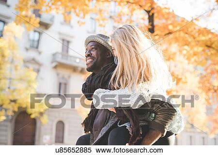 Man giving woman piggyback ride View Large Photo Image Stock Photography - Man giving woman piggyback ride. Fotosearch