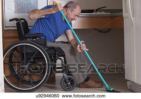 Man in wheelchair cleaning his house View Large Photo Image Stock Image - Man in wheelchair cleaning his house. Fotosearch
