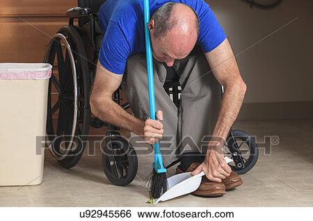 Man in wheelchair cleaning his house View Large Photo Image Stock Photograph - Man in wheelchair cleaning his house. Fotosearch