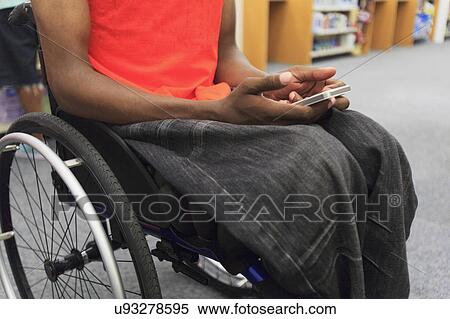 Stock Photography - Man in wheelchair entering a car. Fotosearch