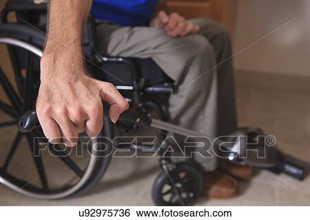 Man in wheelchair vacuuming his house View Large Photo Image Stock Photograph - Man in wheelchair vacuuming his house. Fotosearch