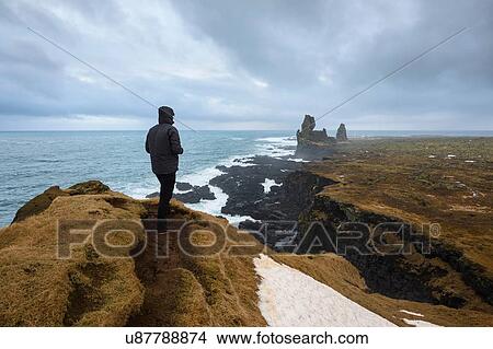 Picture - Man on hill, Londrangar, Snaefellsnes peninsula, Iceland. Fotosearch
