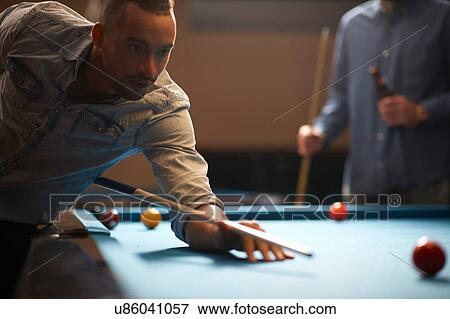 Stock Photo - Man playing pool. Fotosearch