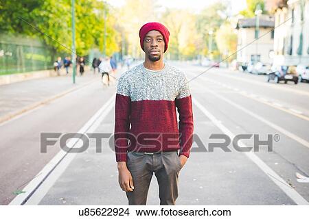 Picture - Man standing on street. Fotosearch