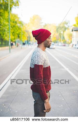 Stock Photograph - Man standing on street. Fotosearch