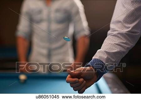 Man tossing coin at pool table View Large Photo Image Stock Photography - Man tossing coin at pool table. Fotosearch