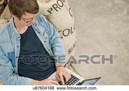 Man using laptop on floor View Large Photo Image Stock Photo - Man using laptop on floor. Fotosearch