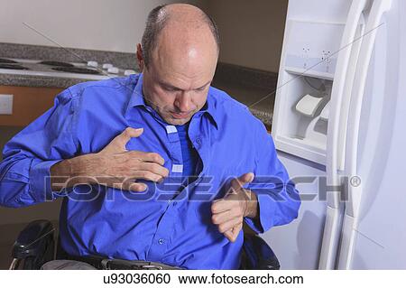 Stock Image - Man with deformed hands dressing up. Fotosearch
