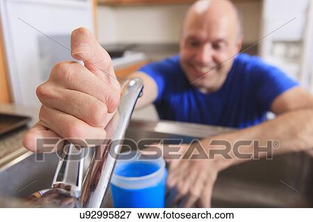 Man with deformed hands in the kitchen View Large Photo Image Stock Photo - Man with deformed hands in the kitchen. Fotosearch