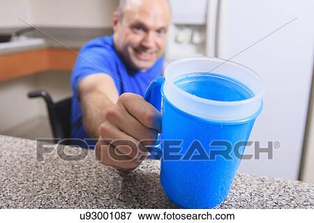 Stock Photo - Man with deformed hands in the kitchen. Fotosearch