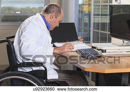Stock Image - Man with deformed hands working as doctor. Fotosearch