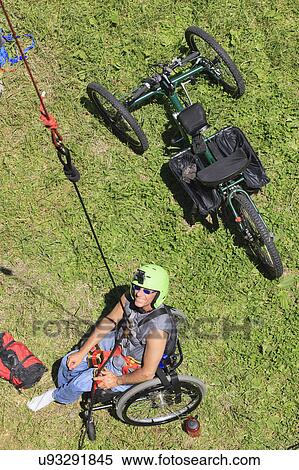 Stock Photography - Man with spinal cord injury rock climbing. Fotosearch