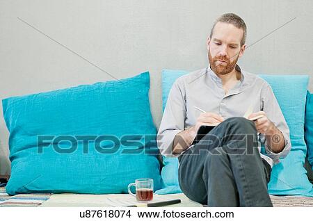 Picture - Man writing notes. Fotosearch