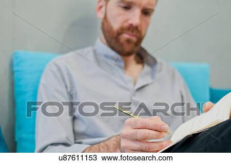 Stock Image - Man writing notes. Fotosearch