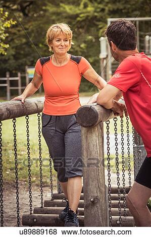 Mature couple using playground equipment to exercise, smiling View Large Photo Image Stock Photo - Mature couple using playground equipment to exercise, smiling. Fotosearch