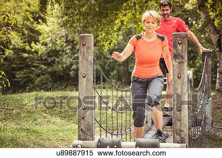 Mature couple using playground equipment to exercise View Large Photo Image Stock Photography - Mature couple using playground equipment to exercise. Fotosearch