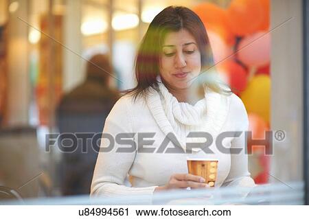 Mature female tourist drinking coffee in cafe window seat, Tokyo, Japan View Large Photo Image Stock Image - Mature female tourist drinking coffee in cafe window seat, Tokyo, Japan. Fotosearch