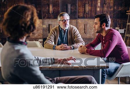 Mature man and two adult sons talking around dining room table View Large Photo Image Stock Image - Mature man and two adult sons talking around dining room table. Fotosearch