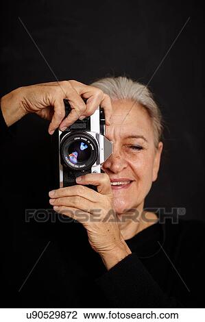 Mature woman taking photograph View Large Photo Image Stock Image - Mature woman taking photograph. Fotosearch