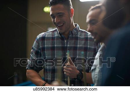 Men with pool cue smiling View Large Photo Image Picture - Men with pool cue smiling. Fotosearch