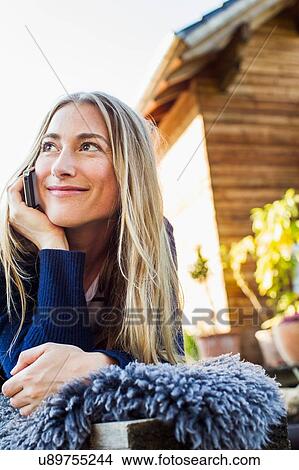 Mid adult woman on smartphone View Large Photo Image Picture - Mid adult woman on smartphone. Fotosearch