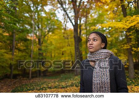 Mid adult woman strolling in autumn forest View Large Photo Image Stock Photo - Mid adult woman strolling in autumn forest. Fotosearch