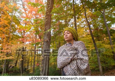 Mid adult woman wrapped in shawl in autumn forest View Large Photo Image Stock Photograph - Mid adult woman wrapped in shawl in autumn forest. Fotosearch