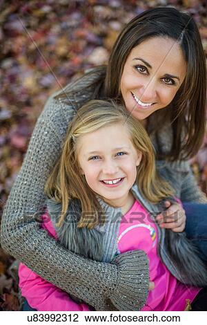Mother and daughter enjoying autumn View Large Photo Image Stock Image - Mother and daughter enjoying autumn. Fotosearch