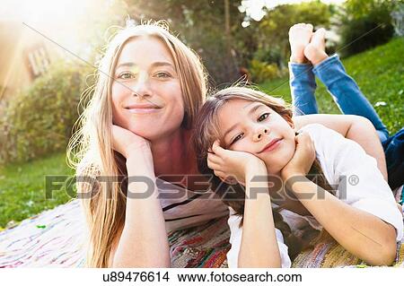 Mother and daughter smiling towards camera View Large Photo Image Picture - Mother and daughter smiling towards camera. Fotosearch
