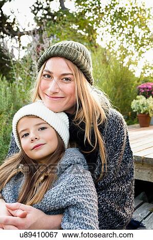 Mother and daughter wearing knitwear and hats, portrait View Large Photo Image Stock Photo - Mother and daughter wearing knitwear and hats, portrait. Fotosearch
