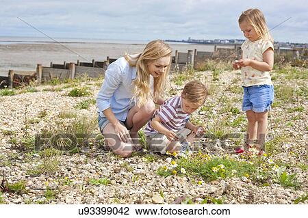 Mother with children on beach View Large Photo Image Stock Image - Mother with children on beach. Fotosearch