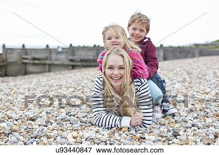 Mother with children on beach View Large Photo Image Stock Photo - Mother with children on beach. Fotosearch