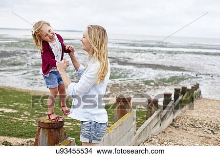 Mother with daughter on beach View Large Photo Image Picture - Mother with daughter on beach. Fotosearch