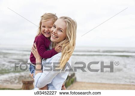 Stock Photo - Mother with daughter on beach. Fotosearch