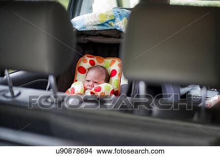 Picture - New born baby in a car seat. Fotosearch