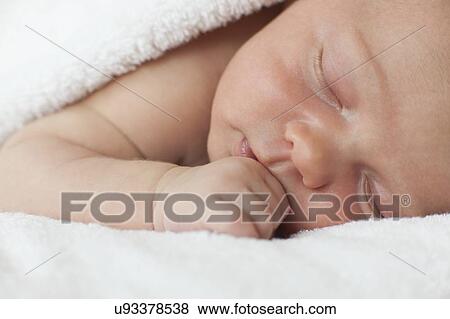 Stock Photo - Newborn baby boy asleep. Fotosearch