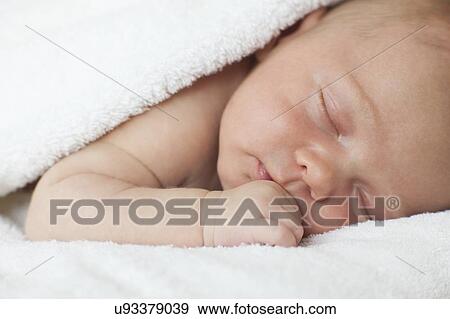 Stock Photo - Newborn baby boy asleep. Fotosearch
