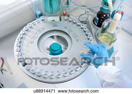 Stock Image - Oil samples in testing machine in laboratory. Fotosearch