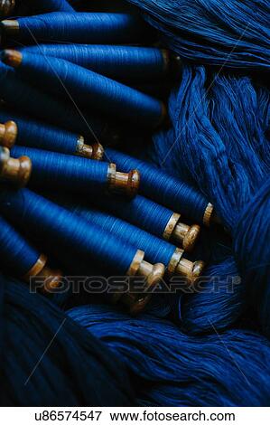 Overhead view of indigo threads and bobbins View Large Photo Image Stock Photo - Overhead view of indigo threads and bobbins. Fotosearch