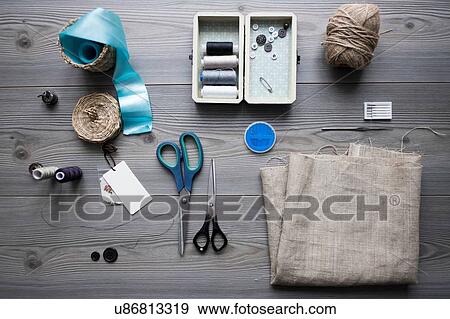 Overhead view of sewing equipment with textiles, threads and scissors View Large Photo Image Stock Photo - Overhead view of sewing equipment with textiles, threads and scissors. Fotosearch