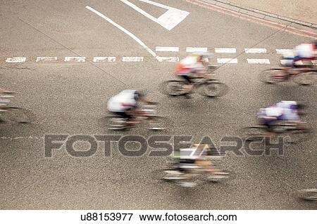 Overhead view of six cyclists speeding on urban road in racing cycle race View Large Photo Image Stock Photo - Overhead view of six cyclists speeding on urban road in racing cycle race. Fotosearch