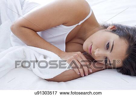 Pensive woman lying awake in bed View Large Photo Image Stock Photo - Pensive woman lying awake in bed. Fotosearch