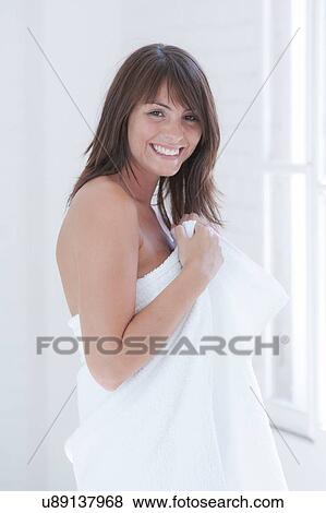 Stock Photo - Portrait of beautiful young woman wrapped in a towel. Fotosearch