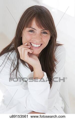 Stock Image - Portrait of beautiful young woman with long brown hair. Fotosearch